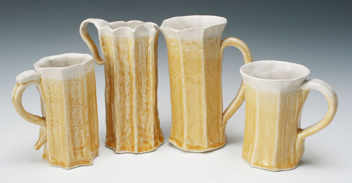 pottery mugs made by employees during a clay workshop
